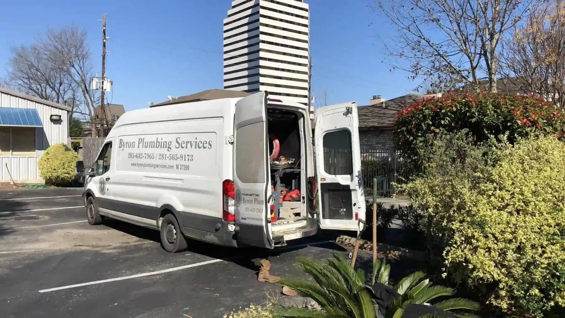 Byron Plumbing Services work van parked outside with its tools and equipment.