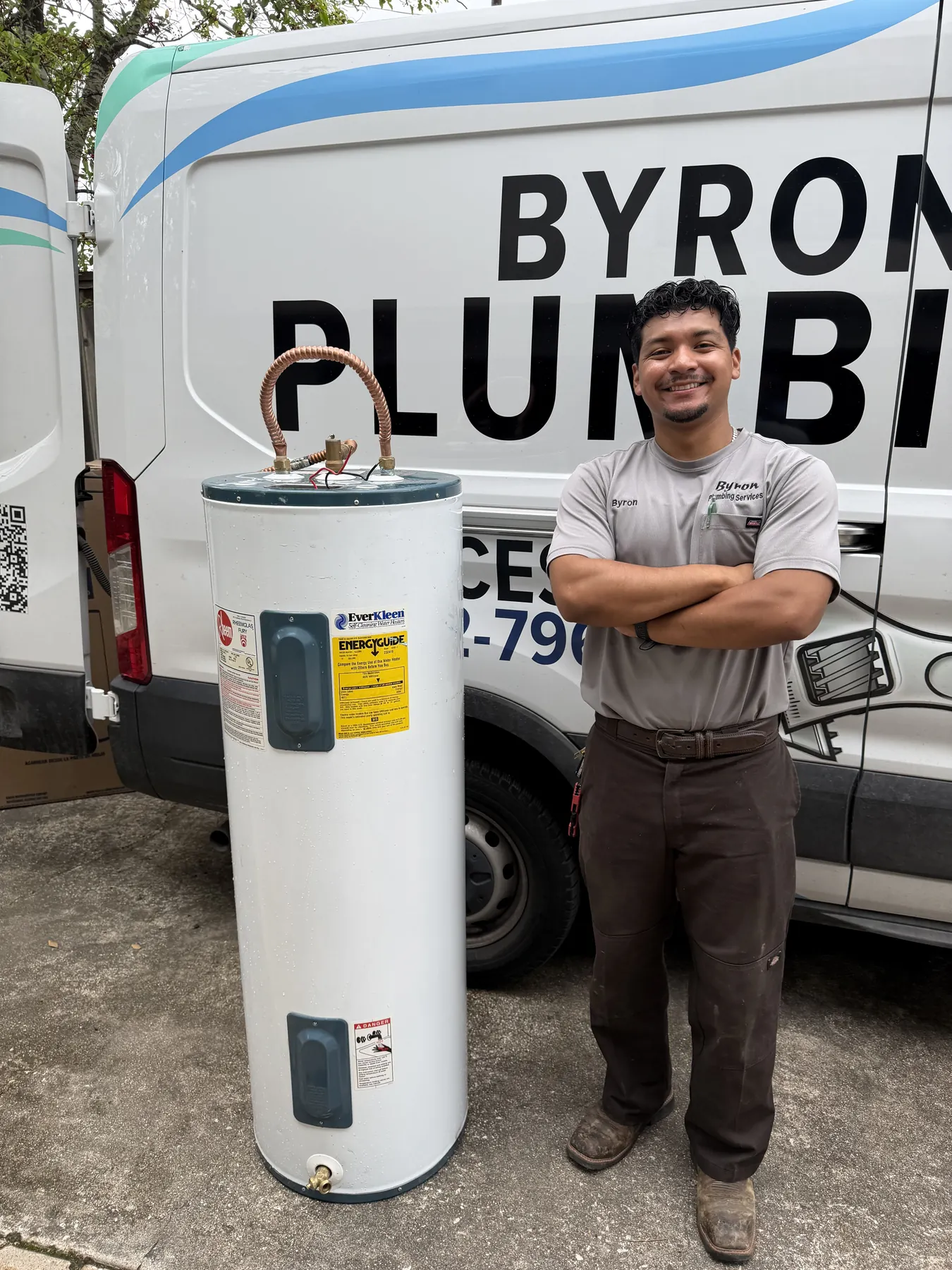 New electric water heater replacement with clean braided supply-line connections.