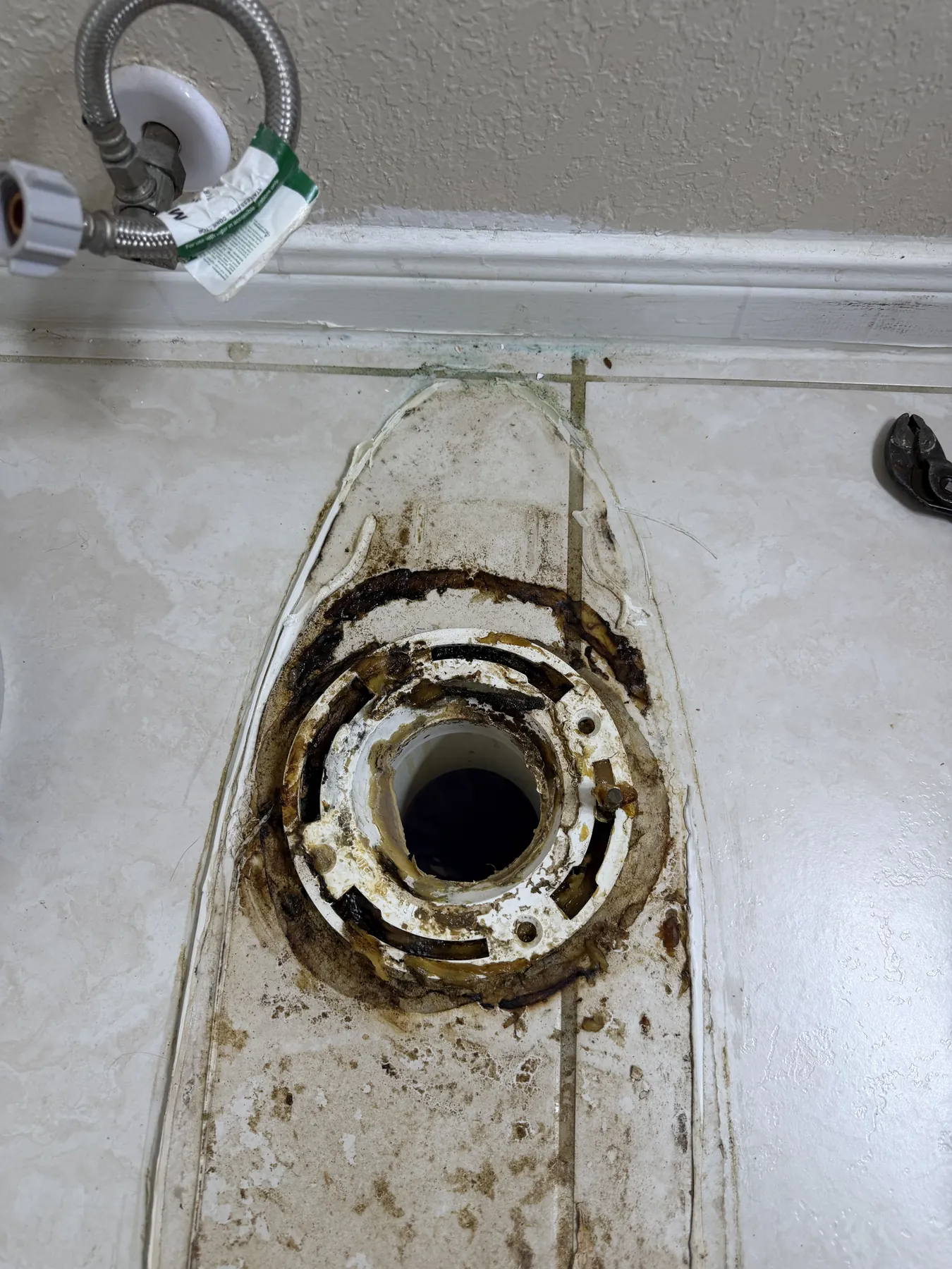 Broken floor flange replaced before the toilet was reset and tested.